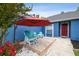 Front of home features a seating area with bench and chairs and an umbrella for shade at 3229 Gardner Oaks Ln, Lakeland, FL 33810