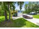 Exterior garage with a car covered with a tarp and a covered outdoor area at 3229 Gardner Oaks Ln, Lakeland, FL 33810