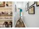 Hallway featuring wood-look floors, light blue walls, and decorative wall art at 3229 Gardner Oaks Ln, Lakeland, FL 33810