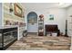 Spacious living room with wood-look floors, fireplace, decor shelving, and an arched doorway at 3229 Gardner Oaks Ln, Lakeland, FL 33810