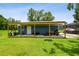 Outbuilding with a blue exterior, a white door, and an extended covered area for extra storage at 3229 Gardner Oaks Ln, Lakeland, FL 33810