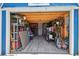Outbuilding with a wood ceiling, light gray floor, and organized storage with shelving and tools at 3229 Gardner Oaks Ln, Lakeland, FL 33810