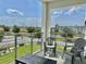 Relaxing outdoor balcony with seating, offering scenic views of the surrounding community and lush greenery at 4751 Clock Tower Dr # 307, Kissimmee, FL 34746