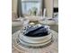 Formal table setting with dinnerware and linens at 4751 Clock Tower Dr # 307, Kissimmee, FL 34746
