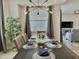 Stylish dining area with decorative accents, large window, and adjacent living space at 4751 Clock Tower Dr # 307, Kissimmee, FL 34746