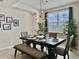 Inviting dining area with stylish lighting, a large window, and seating for comfortable meals at 4751 Clock Tower Dr # 307, Kissimmee, FL 34746