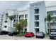 Modern apartment building with multiple stories, balconies and well-maintained landscaping at 4751 Clock Tower Dr # 307, Kissimmee, FL 34746