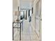 A bright hallway with tile flooring, decorated with furniture, leads to the dining and living spaces at 4751 Clock Tower Dr # 307, Kissimmee, FL 34746