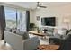 Comfortable living room with plush seating, a flat-screen TV, and access to a balcony through large sliding glass doors at 4751 Clock Tower Dr # 307, Kissimmee, FL 34746