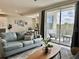 Comfortable living area with a large window offering natural light and access to an outdoor balcony at 4751 Clock Tower Dr # 307, Kissimmee, FL 34746