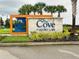 The Cove at Storey Lake community entrance with lush landscaping and an inviting entrance sign at 4751 Clock Tower Dr # 307, Kissimmee, FL 34746