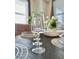 Elegant table setting featuring crystal glassware and decorative place mats, enhancing the dining experience at 4751 Clock Tower Dr # 307, Kissimmee, FL 34746