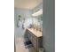 Bathroom featuring double vanity, light blue walls, and tropical-themed decor, creating a serene atmosphere at 17569 Se 107Th Ct, Summerfield, FL 34491