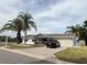 Inviting single-story home featuring a manicured lawn, brick driveway and attached garage at 17569 Se 107Th Ct, Summerfield, FL 34491
