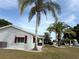 Charming single-story home with a well-manicured lawn, and lovely palm trees in a desirable neighborhood at 17569 Se 107Th Ct, Summerfield, FL 34491
