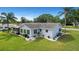 Aerial view of the home with large yard, lush landscaping, screened porch and manicured shrubbery at 17569 Se 107Th Ct, Summerfield, FL 34491
