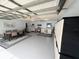 Versatile garage space with dining area, laundry, storage, and convenient access to the rest of the home at 17569 Se 107Th Ct, Summerfield, FL 34491