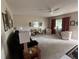 Spacious living room with plush carpeting, ceiling fan and plenty of natural light at 17569 Se 107Th Ct, Summerfield, FL 34491