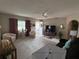 Cozy living room featuring neutral walls, plush carpet, and stylish furnishings at 17569 Se 107Th Ct, Summerfield, FL 34491