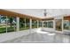 Bright sunroom with multiple large windows offering ample natural light and views of the neighborhood at 17569 Se 107Th Ct, Summerfield, FL 34491