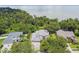 Aerial view showcases the backyard proximity to a lake, trees, and neighborhood at 297 Beacon Pointe Dr, Ocoee, FL 34761