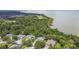 A stunning aerial view of the homes, lush greenery, and waterfront offering serene living at 297 Beacon Pointe Dr, Ocoee, FL 34761