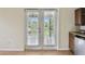 Balcony access featuring white frame doors, overlooking nature at 297 Beacon Pointe Dr, Ocoee, FL 34761