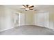 Comfortable bedroom with carpet, ceiling fan, closet, and a doorway leading to other areas of the home at 297 Beacon Pointe Dr, Ocoee, FL 34761
