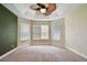 Large bedroom with tray ceilings, a ceiling fan, and three large windows at 297 Beacon Pointe Dr, Ocoee, FL 34761