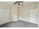 Bedroom with neutral carpet, ceiling fan and double door closet at 297 Beacon Pointe Dr, Ocoee, FL 34761