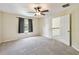 Inviting bedroom with neutral carpet, a ceiling fan, and a window providing natural light and ventilation at 297 Beacon Pointe Dr, Ocoee, FL 34761