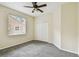 Bedroom with neutral carpet, ceiling fan, and a window at 297 Beacon Pointe Dr, Ocoee, FL 34761