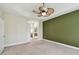 Spacious bedroom with neutral carpeting, tray ceiling, and a fan for added comfort at 297 Beacon Pointe Dr, Ocoee, FL 34761