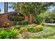 Beautiful community entrance sign with lush landscaping and colorful flowers creating an inviting atmosphere at 297 Beacon Pointe Dr, Ocoee, FL 34761