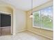 Bright dining room featuring tile flooring, a hanging light fixture, and large windows at 297 Beacon Pointe Dr, Ocoee, FL 34761