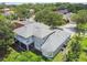 Aerial view of a two-story home with a screened in porch, balcony, and lush landscaping at 297 Beacon Pointe Dr, Ocoee, FL 34761