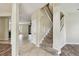 Home entryway with tiled floor and carpeted stairs at 297 Beacon Pointe Dr, Ocoee, FL 34761