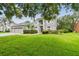 Charming two-story home with a well-manicured lawn, mature trees, and an attached three-car garage at 297 Beacon Pointe Dr, Ocoee, FL 34761