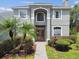 Charming two-story home with well-maintained landscaping, walkway, and a welcoming entryway at 297 Beacon Pointe Dr, Ocoee, FL 34761