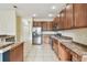 Modern kitchen with stainless steel appliances, granite countertops, and tile flooring at 297 Beacon Pointe Dr, Ocoee, FL 34761