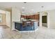 Open kitchen with stainless steel appliances, breakfast bar with seating, and tile flooring at 297 Beacon Pointe Dr, Ocoee, FL 34761