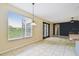 Open living area with tile flooring and view of the french doors and adjacent kitchen at 297 Beacon Pointe Dr, Ocoee, FL 34761