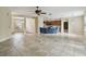 Open living area with tile flooring and view into the kitchen with breakfast bar seating at 297 Beacon Pointe Dr, Ocoee, FL 34761