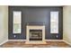 Cozy living room with a tiled fireplace, dark accent wall, and bright windows at 297 Beacon Pointe Dr, Ocoee, FL 34761