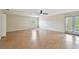 Spacious living room with hardwood floors, natural light, and access to balcony at 297 Beacon Pointe Dr, Ocoee, FL 34761