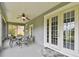 A covered patio with seating offers a relaxing outdoor space, conveniently located next to interior access at 297 Beacon Pointe Dr, Ocoee, FL 34761