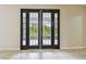 Double doors leading to the outdoor living space provide ample natural light at 297 Beacon Pointe Dr, Ocoee, FL 34761