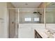 Tiled shower with glass door, rain shower head, and a handheld sprayer at 297 Beacon Pointe Dr, Ocoee, FL 34761
