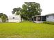Spacious backyard featuring a storage shed and a lush green lawn at 5 Moonlight Ln, Winter Haven, FL 33884