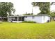 Exterior view of home featuring a lush green lawn at 5 Moonlight Ln, Winter Haven, FL 33884